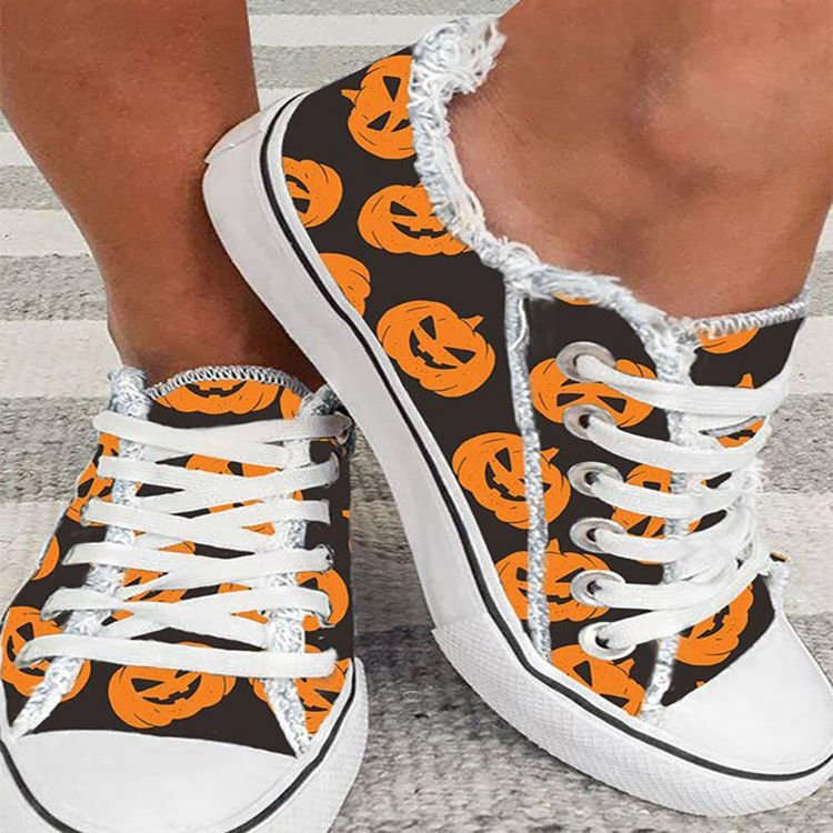 Black canvas sneakers with Halloween pumpkin print and frayed edges for women