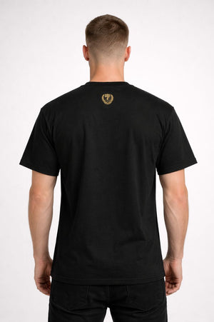 Person wearing a black t-shirt with a logo on the back against a white background