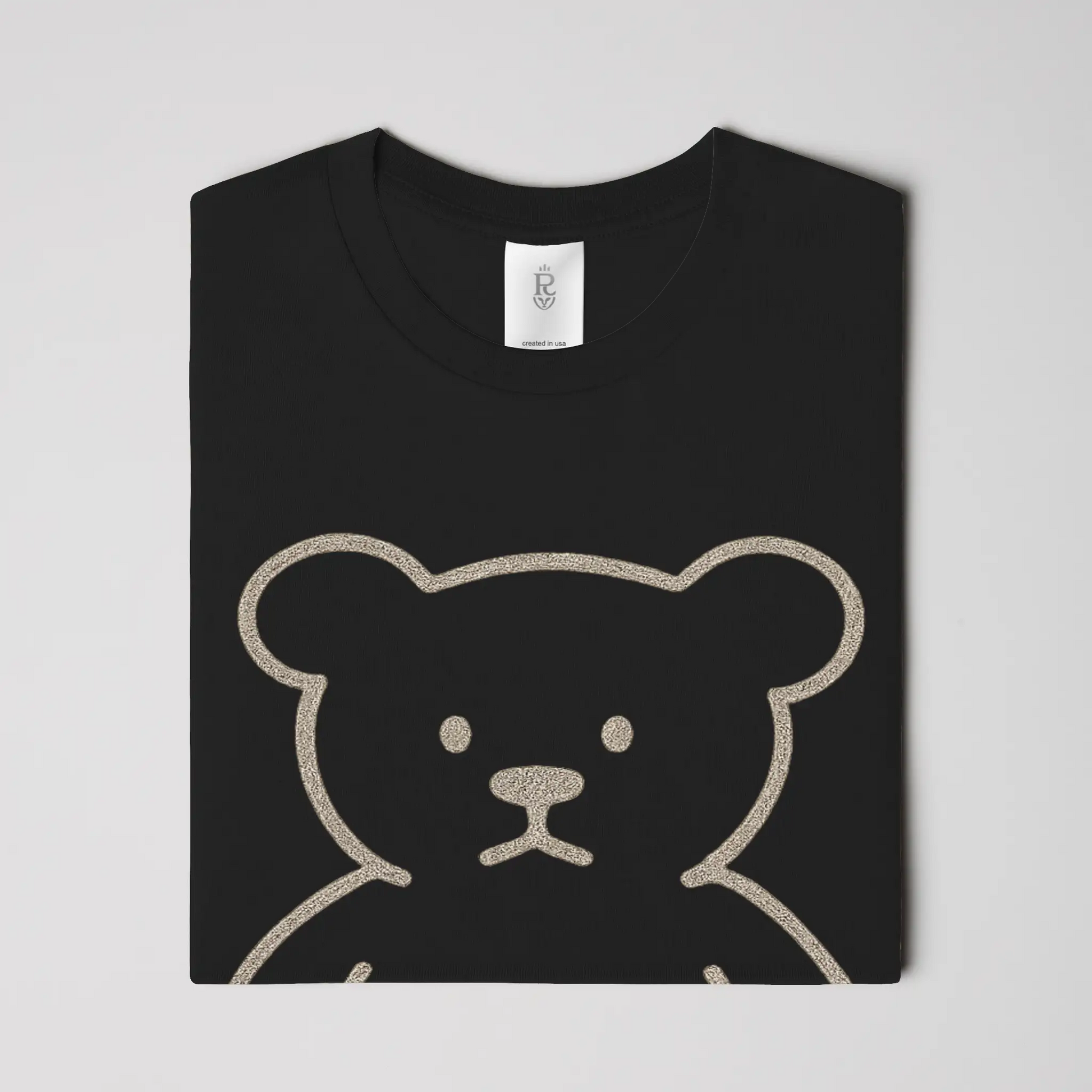 Premium minimalist teddy bear graphic t-shirt with gold crest logo on back in black and white colorways