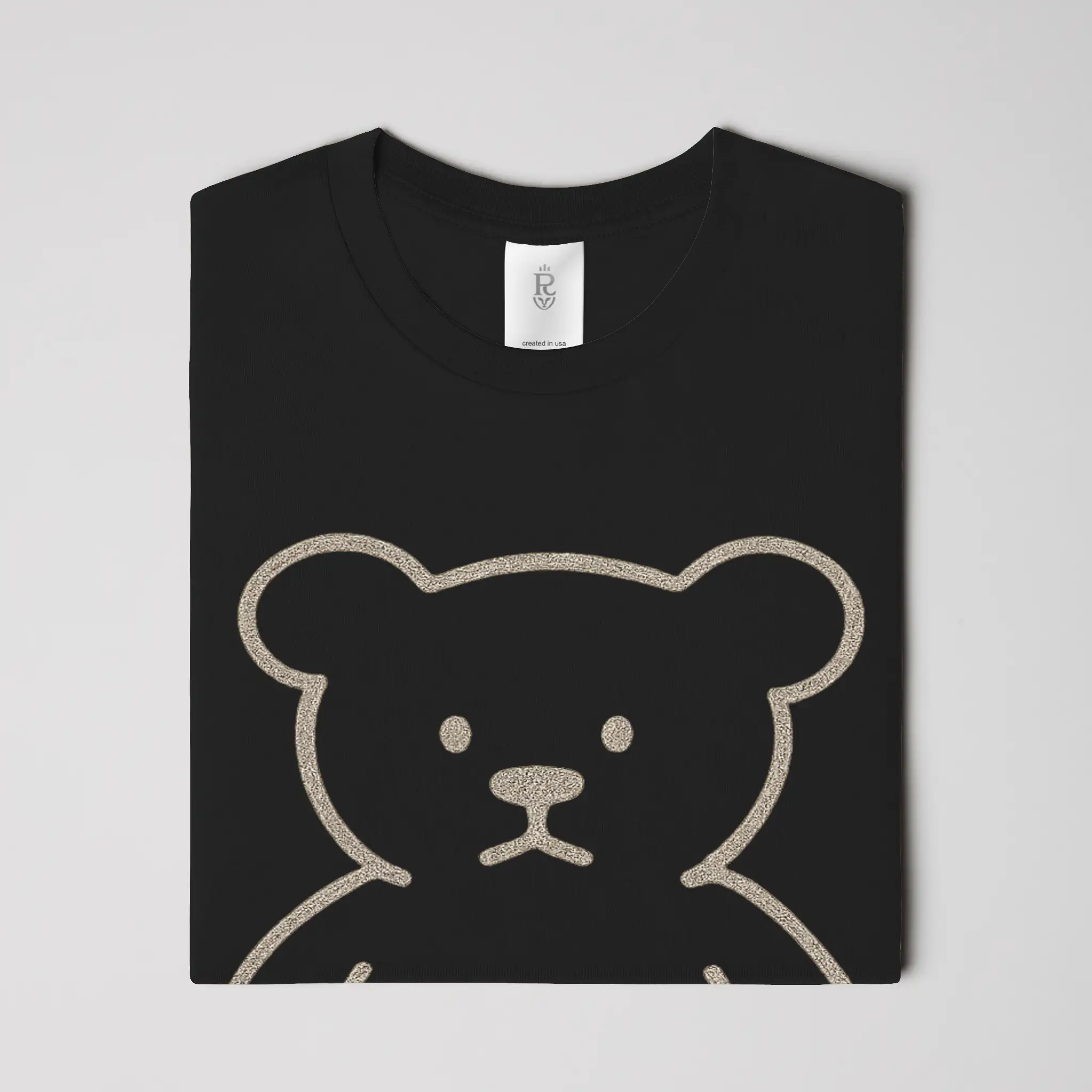 Premium minimalist teddy bear graphic t-shirt with gold crest logo on back in black and white colorways