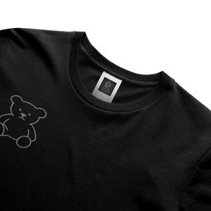 Black streetwear t-shirt featuring small gold crest logo on upper back, minimalist premium design