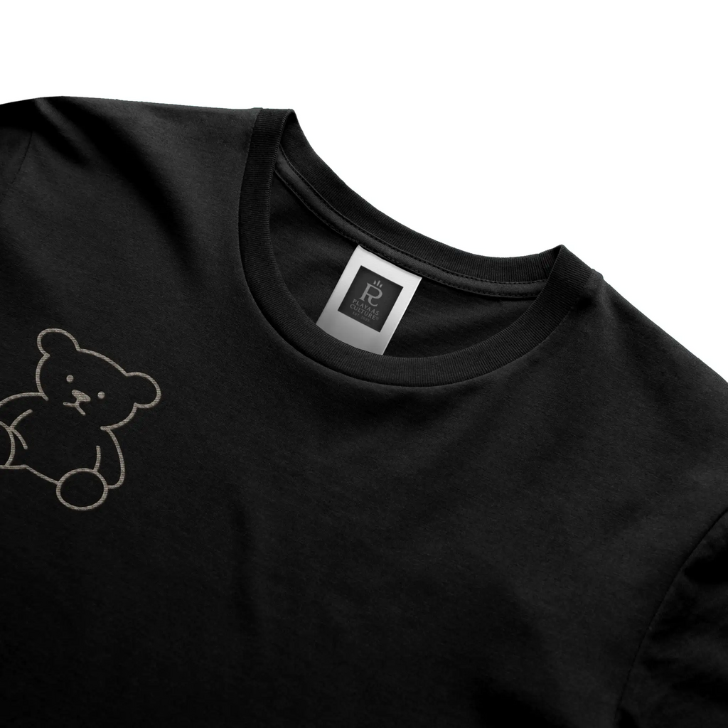 Black streetwear t-shirt featuring small gold crest logo on upper back, minimalist premium design