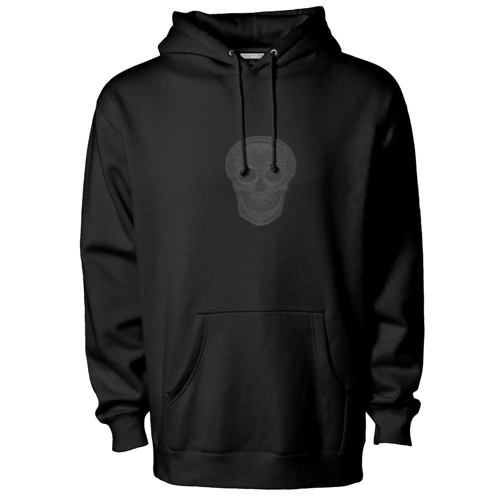Black heavyweight streetwear hoodie featuring a subtle skull graphic on the front and a distressed cross design on the back in black-on-black tonal print.