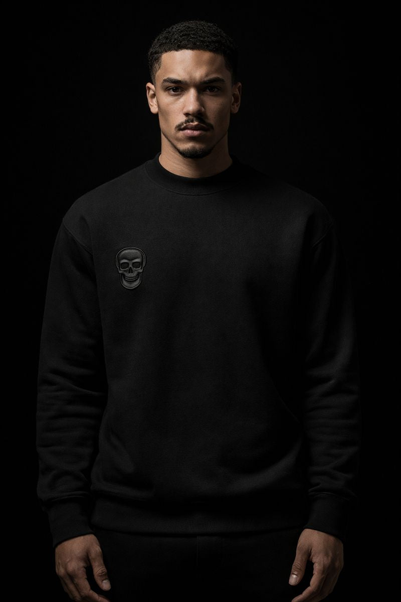 Man wearing a black sweatshirt with a logo on a black background
