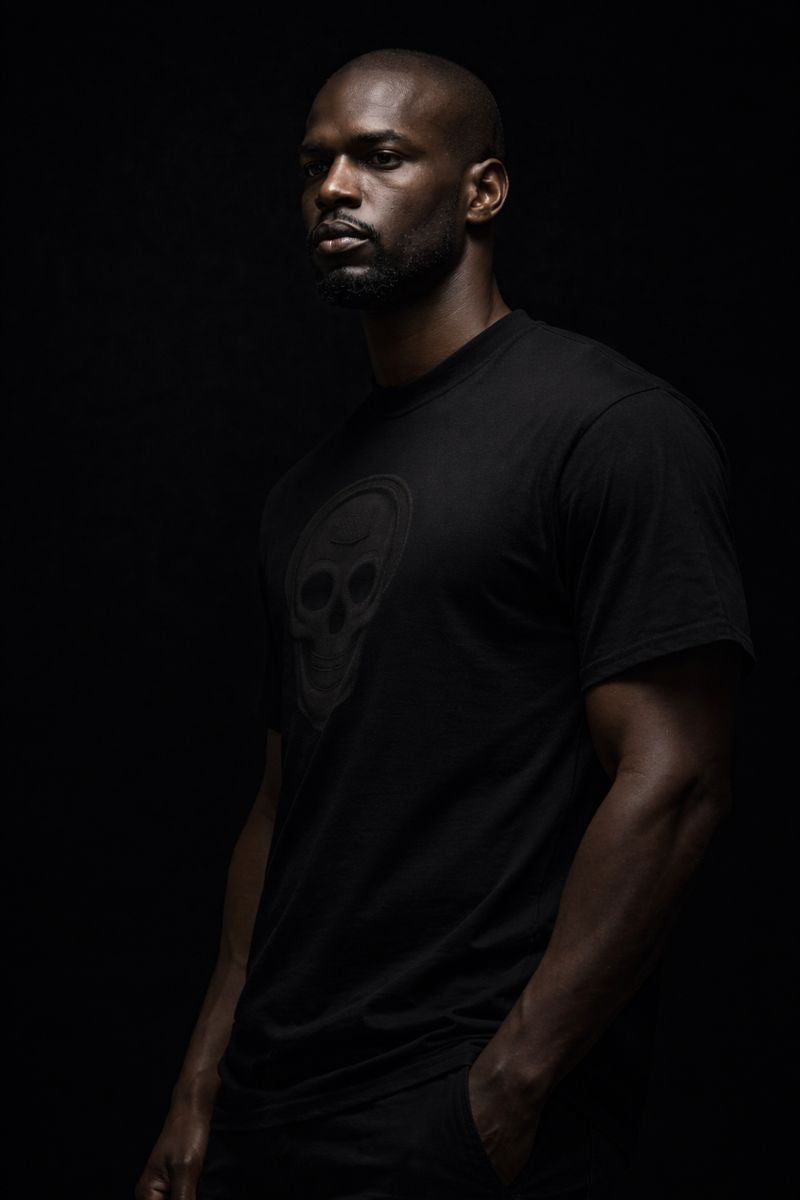 Luxury streetwear T-shirt featuring skull front graphic and dripped cross back design. PLAYAAS CULTURE® delivers bold symbolism, premium fit, and Blackpresure-driven identity.