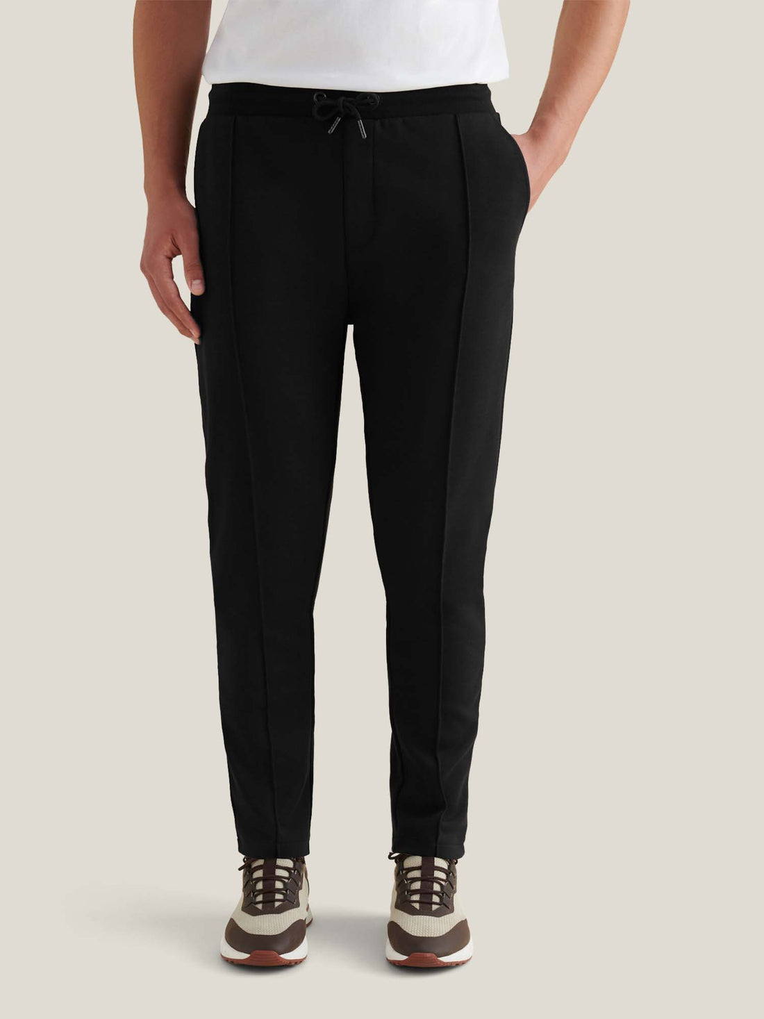 Black Jersey Interlock Jogger with double-faced fabric, pintuck front, ribbed waistband, tapered legs, and side pockets