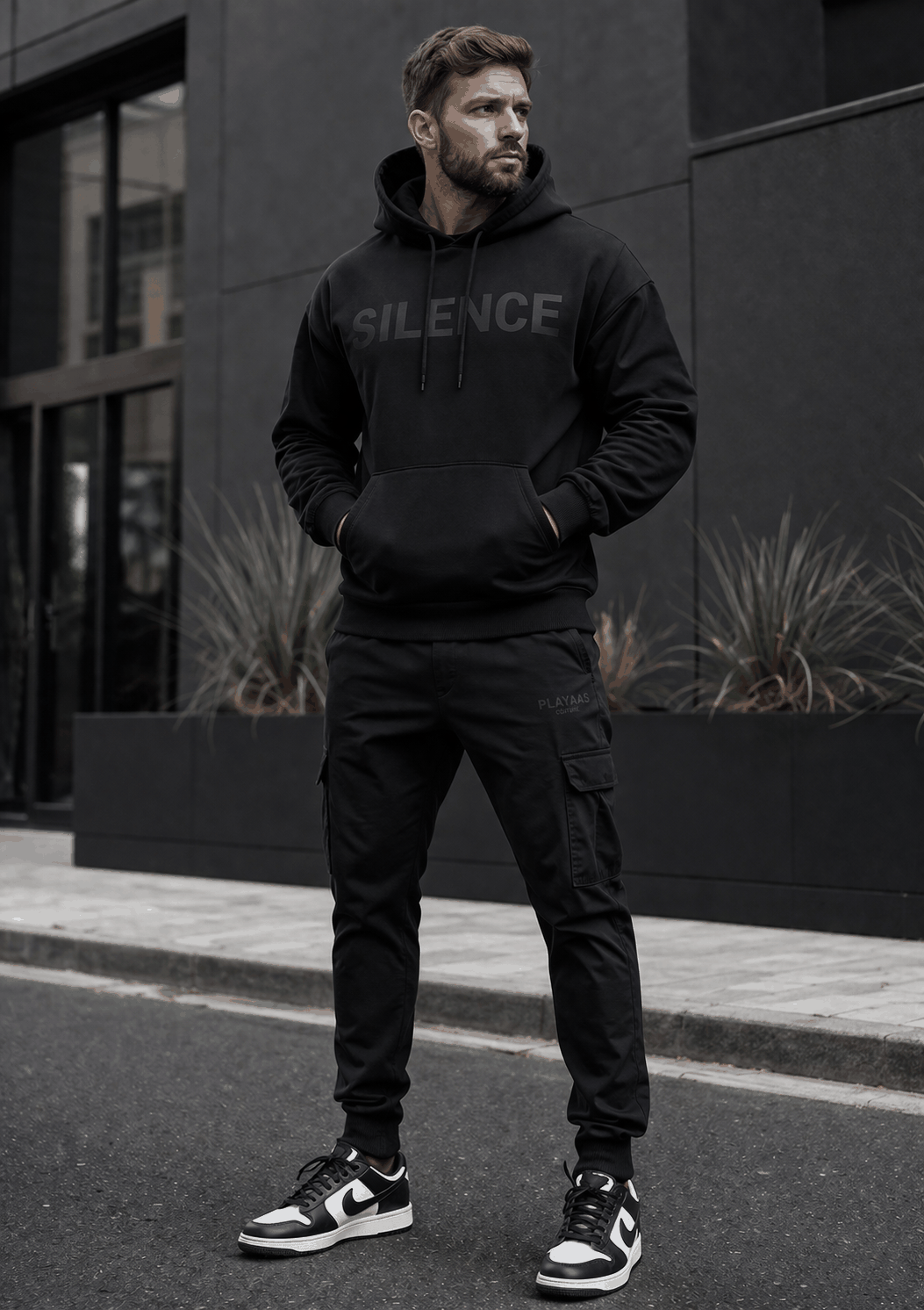 Black SILENCE Hoodie with tonal chest graphic, adjustable hood, kangaroo pocket, and minimalist luxury streetwear design.
