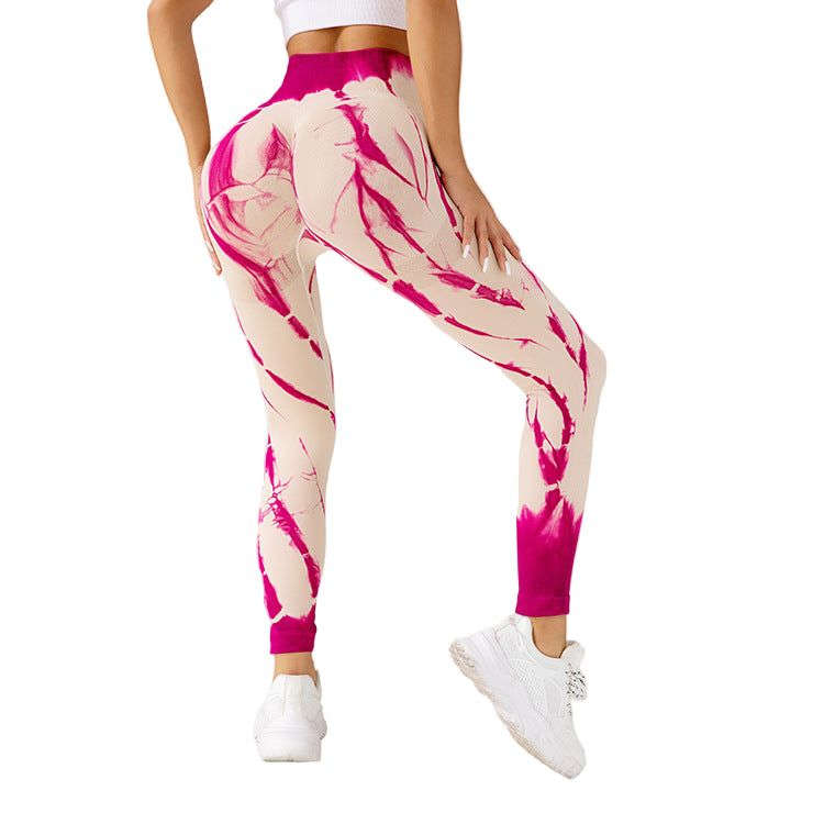Women wearing seamless tie-dye yoga pants in vibrant red, black, and blue high-waisted leggings for fitness and running