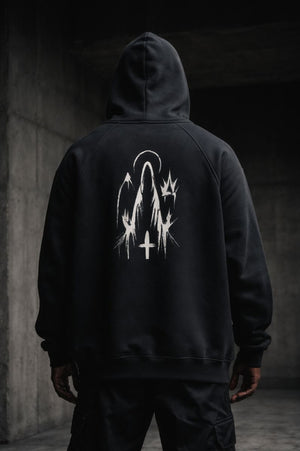 Black premium streetwear hoodie with gold chest crest and symbolic back graphic worn by a Black male model in a minimalist luxury photoshoot.