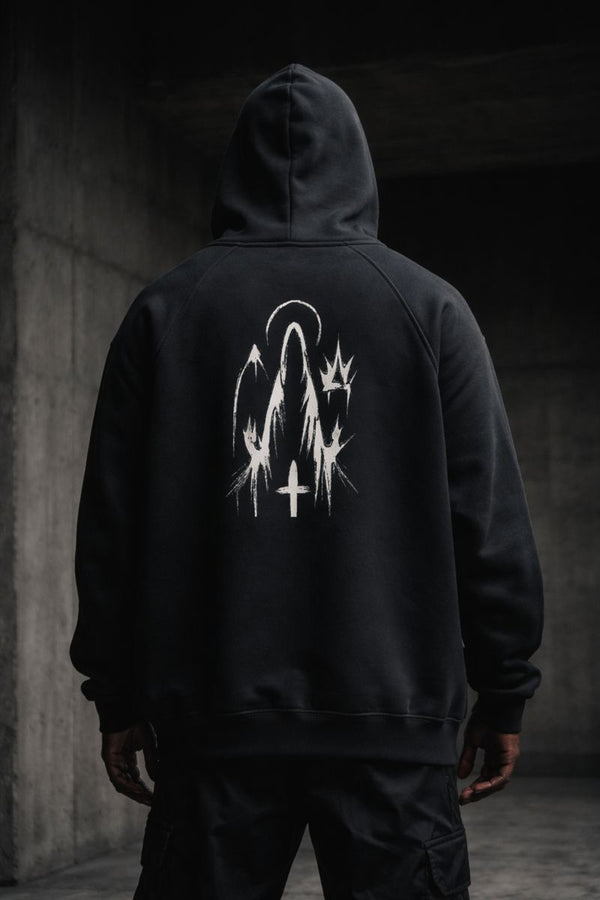 Black premium streetwear hoodie with gold chest crest and symbolic back graphic worn by a Black male model in a minimalist luxury photoshoot.