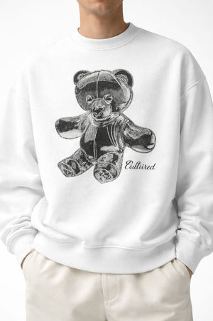 White male model wearing PLAYAAS CULTURE® Cultured oversized heavyweight sweatshirt with teddy bear graphic, front view.