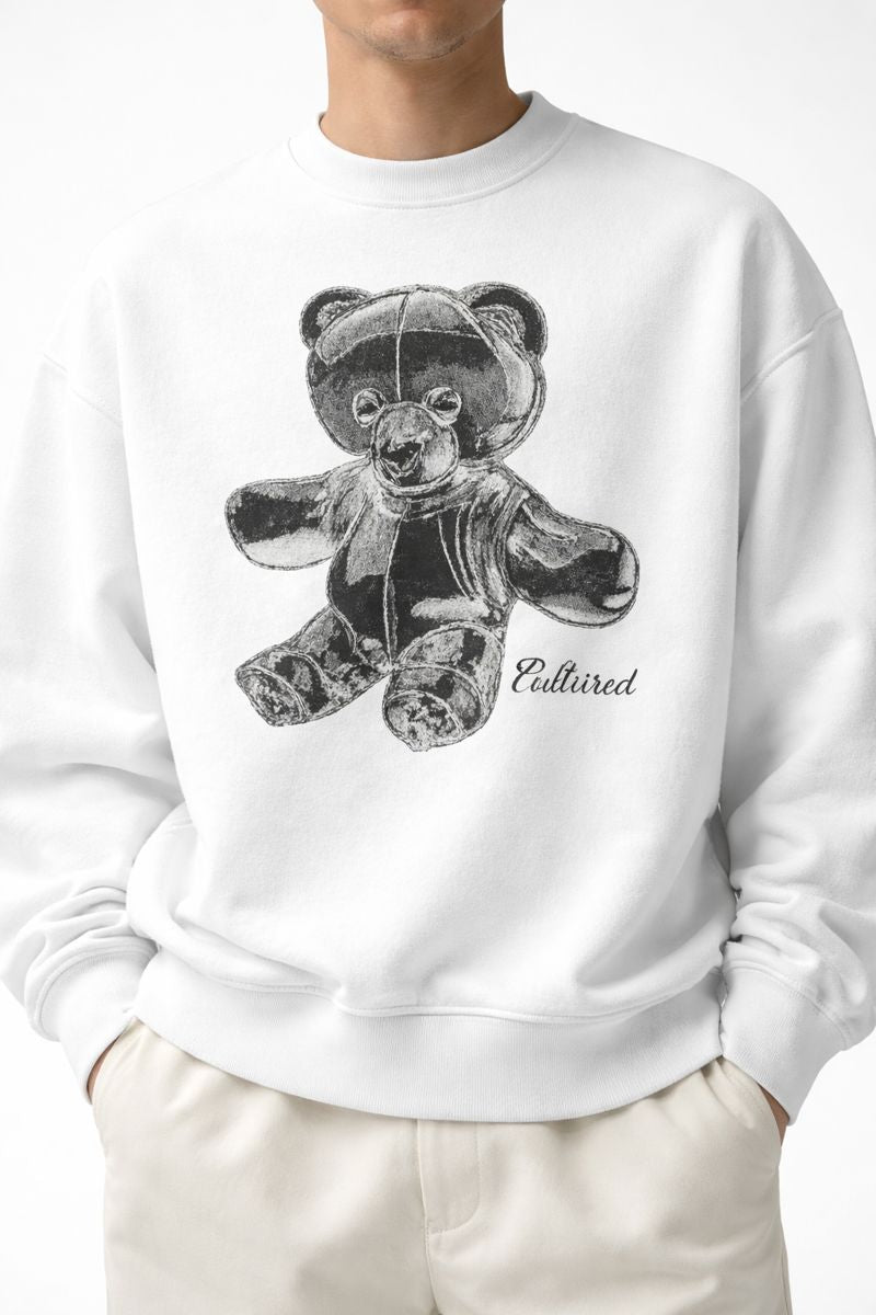 White male model wearing PLAYAAS CULTURE® Cultured oversized heavyweight sweatshirt with teddy bear graphic, front view.